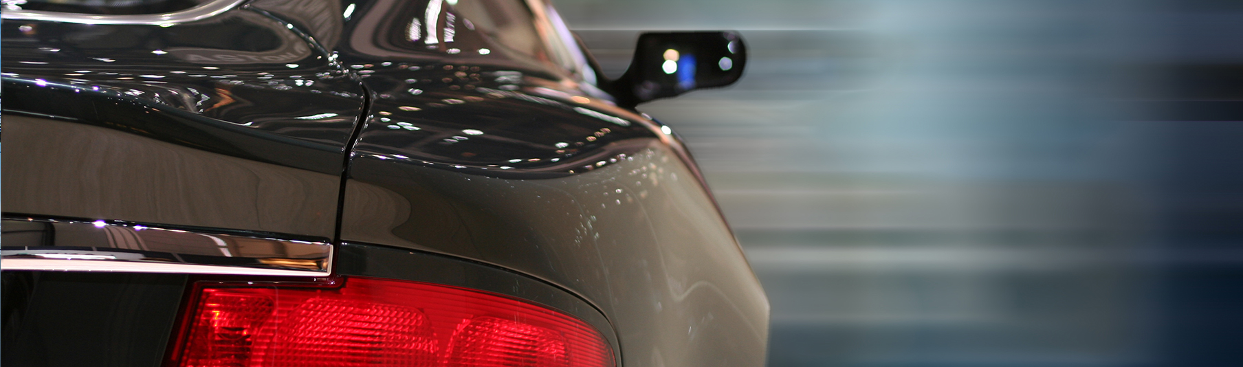 Motor Insurance: Close-up of the back side of a dark grey car