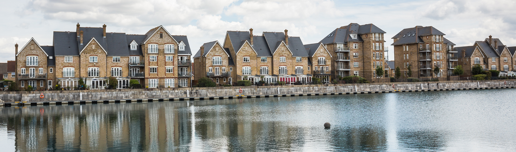 Property Insurance: Terraced houses and their reflection in the river opposite